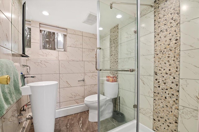 740 Eagle Dr, North Woodmere, NY 11581 - bathroom with tile walls, marble look tiles, a stall shower, baseboard heating, and recessed lighting
