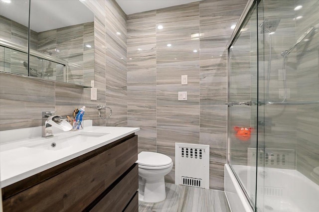 740 Eagle Dr, North Woodmere, NY 11581 - full bath with tile walls, vanity, enclosed tub / shower combo, and radiator heating unit