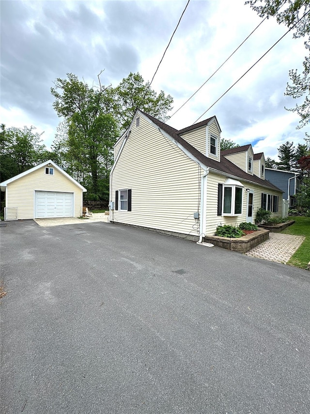 21 Maple Dr, Middletown, NY 10940 - view of side of property featuring a detached garage and an outbuilding