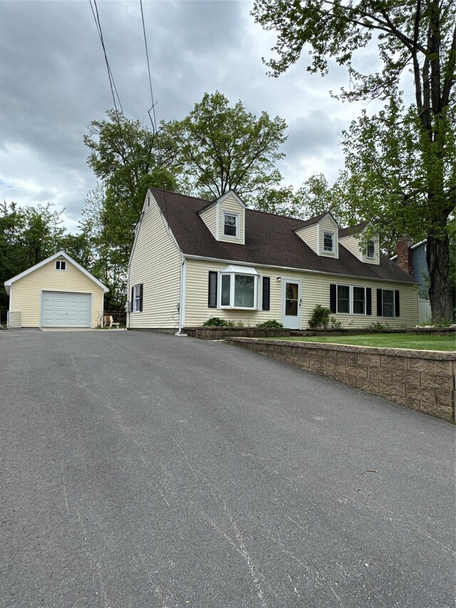 21 Maple Dr, Middletown, NY 10940 - cape cod house with a garage, an outbuilding, and driveway