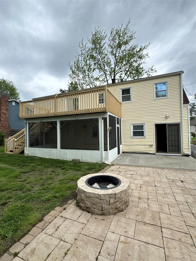 21 Maple Dr, Middletown, NY 10940 - back of property featuring a sunroom, a patio area, a fire pit, and a lawn