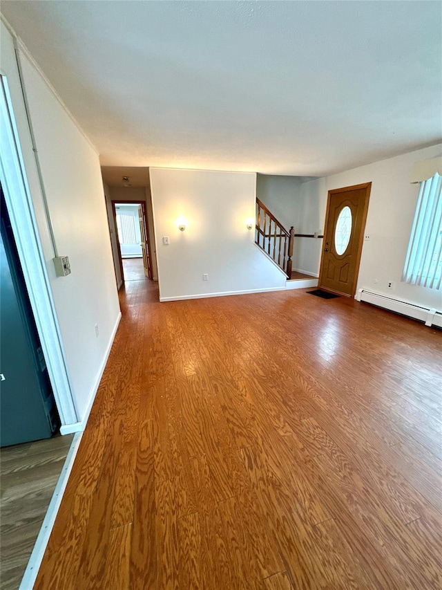21 Maple Dr, Middletown, NY 10940 - unfurnished living room with wood finished floors, stairs, a baseboard radiator, and plenty of natural light
