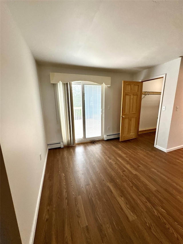 21 Maple Dr, Middletown, NY 10940 - unfurnished bedroom with a baseboard heating unit, dark wood-style flooring, access to outside, and a closet