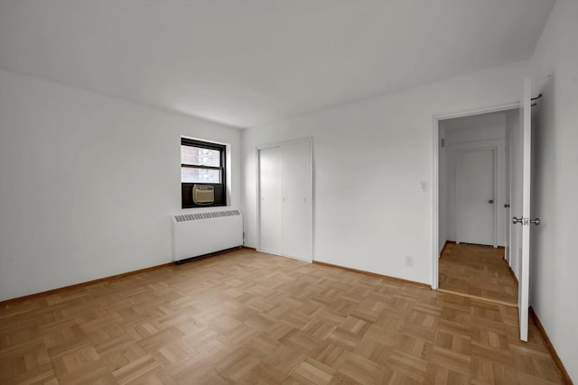 21-15 34th Ave Unit 8B, Astoria, NY 11106 - spare room with radiator heating unit and cooling unit
