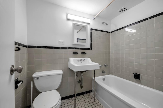 21-15 34th Ave Unit 8B, Astoria, NY 11106 - bathroom with tile walls, shower / washtub combination, tile patterned floors, and wainscoting
