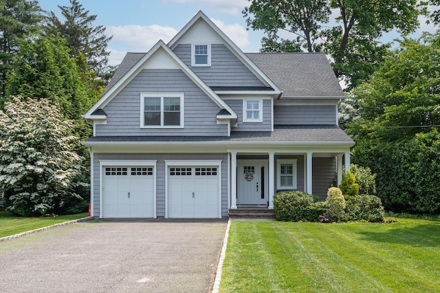 28 Weir Ln, Locust Valley, NY 11560 - view of front of house with driveway, a front yard, an attached garage, roof with shingles, and a porch