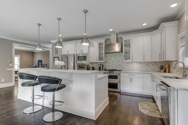 28 Weir Ln, Locust Valley, NY 11560 - kitchen featuring stainless steel appliances, wall chimney exhaust hood, backsplash, a kitchen island, and ornamental molding