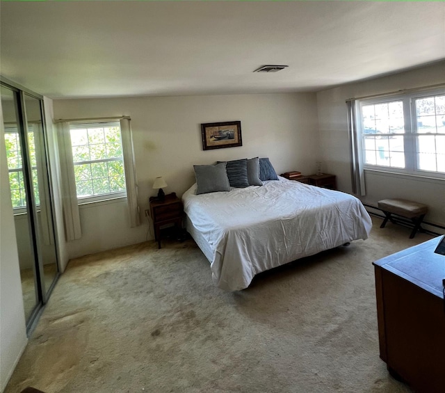 60 Revere Dr, Sayville, NY 11782 - bedroom with multiple windows, carpet, and baseboard heating