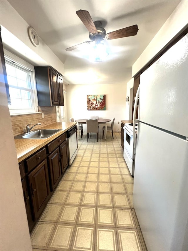 60 Revere Dr, Sayville, NY 11782 - kitchen featuring white appliances, a ceiling fan, dark brown cabinets, light countertops, and decorative backsplash