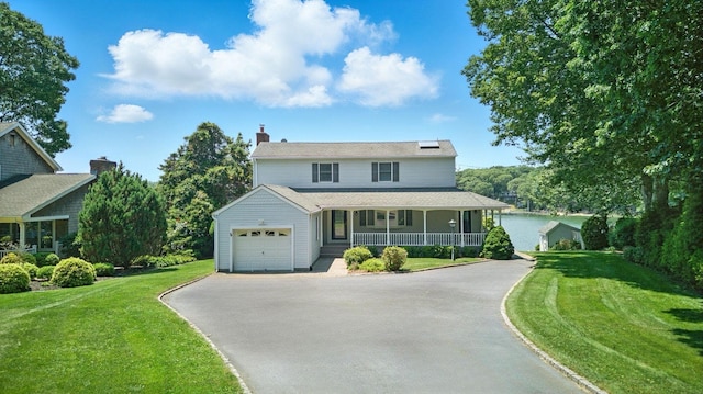 2005 Westview Dr, Mattituck, NY 11952 - view of front of property with covered porch, driveway, a front lawn, a garage, and a chimney