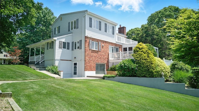 2005 Westview Dr, Mattituck, NY 11952 - rear view of property with a chimney, a yard, brick siding, and a balcony