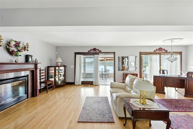 2005 Westview Dr, Mattituck, NY 11952 - living area featuring plenty of natural light, a glass covered fireplace, and light wood-style flooring