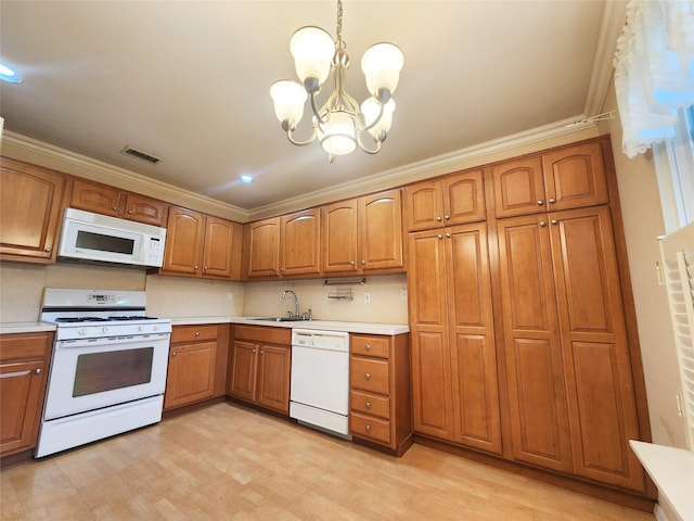 12 Grouse Path, Coram, NY 11727 - kitchen with white appliances, brown cabinets, light countertops, a chandelier, and crown molding
