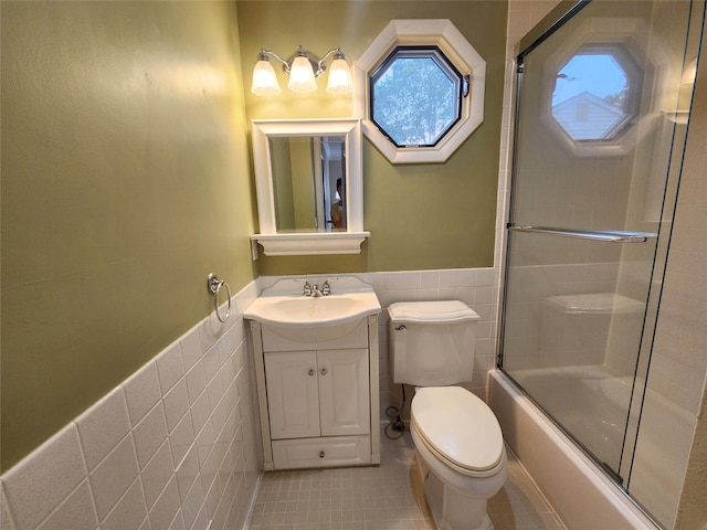 12 Grouse Path, Coram, NY 11727 - full bathroom with tile walls, tile patterned flooring, vanity, shower / bath combination with glass door, and wainscoting