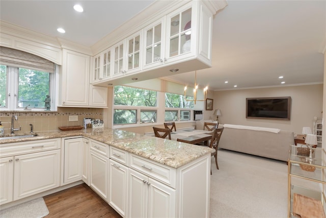 18 Channing Pl Unit 2R, Eastchester, NY 10709 - kitchen with crown molding, plenty of natural light, recessed lighting, light stone countertops, and a peninsula