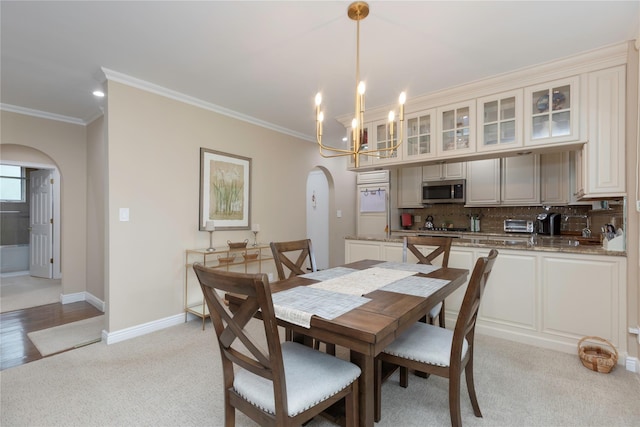 18 Channing Pl Unit 2R, Eastchester, NY 10709 - dining space featuring arched walkways, crown molding, light colored carpet, and a chandelier