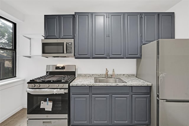 2506 Davidson Ave Unit 3C, Bronx, NY 10468 - kitchen featuring appliances with stainless steel finishes, gray cabinets, light tile patterned floors, and light stone counters