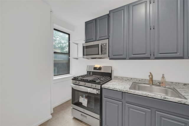 2506 Davidson Ave Unit 3C, Bronx, NY 10468 - kitchen with appliances with stainless steel finishes, gray cabinets, light countertops, and light tile patterned floors