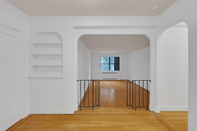 2506 Davidson Ave Unit 3C, Bronx, NY 10468 - hall featuring an upstairs landing, arched walkways, hardwood / wood-style flooring, built in features, and crown molding