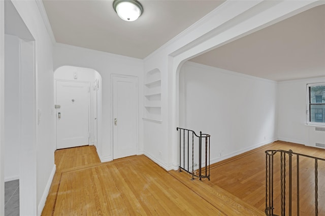 2506 Davidson Ave Unit 3C, Bronx, NY 10468 - hallway with arched walkways, light wood finished floors, crown molding, radiator heating unit, and built in features
