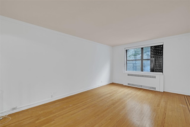 2506 Davidson Ave Unit 3C, Bronx, NY 10468 - empty room with radiator, wood finished floors, and ornamental molding