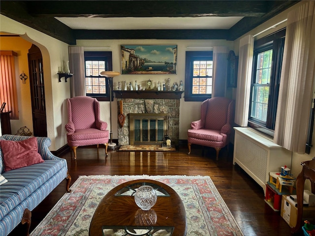 163-49 16th Ave, Whitestone, NY 11357 - living room with radiator heating unit, wood finished floors, healthy amount of natural light, and a fireplace