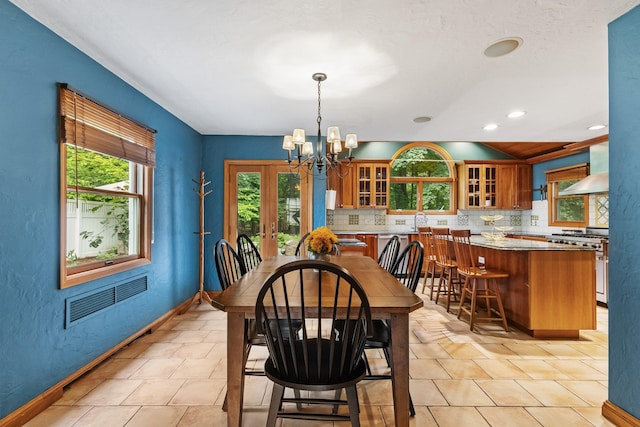 100 Norman Rd, New Rochelle, NY 10804 - dining space featuring a chandelier, a textured wall, and recessed lighting