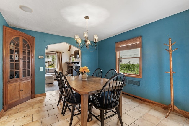 100 Norman Rd, New Rochelle, NY 10804 - dining room featuring arched walkways, a chandelier, and light tile patterned floors