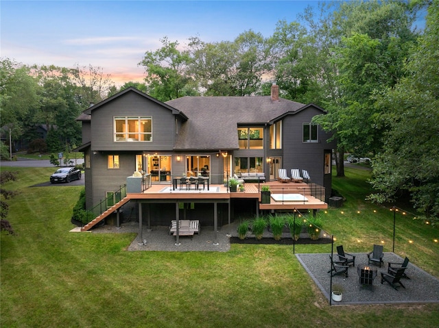 12 Zeck Ct, Suffern, NY 10901 - back of house at dusk with a deck, a chimney, a yard, and stairway