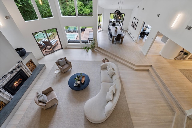 12 Zeck Ct, Suffern, NY 10901 - living area featuring a high ceiling, a lit fireplace, and wood finished floors