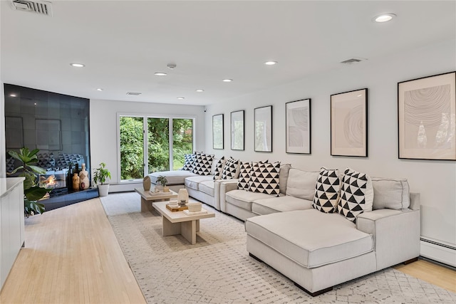 12 Zeck Ct, Suffern, NY 10901 - living area featuring a baseboard heating unit, recessed lighting, and light wood-style floors