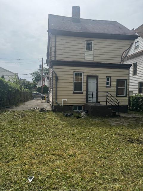 111 S Fulton Ave, Mount Vernon, NY 10550 - back of house with a chimney and a lawn