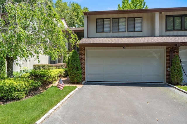 10 Pond View Ct Unit 10, Jericho, NY 11753 - split level home featuring brick siding, an attached garage, asphalt driveway, and roof with shingles