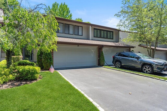 10 Pond View Ct Unit 10, Jericho, NY 11753 - view of front facade featuring driveway, a garage, a front yard, and brick siding