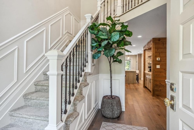 10 Pond View Ct Unit 10, Jericho, NY 11753 - stairs featuring a decorative wall, wood finished floors, wainscoting, and recessed lighting
