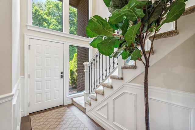 10 Pond View Ct Unit 10, Jericho, NY 11753 - entryway featuring wainscoting, stairs, healthy amount of natural light, and a decorative wall