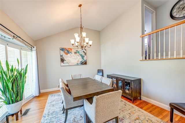 163 W 24th St, Deer Park, NY 11729 - dining area with wood finished floors, plenty of natural light, a chandelier, and lofted ceiling