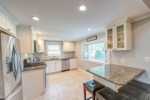 163 W 24th St, Deer Park, NY 11729 - kitchen with stainless steel appliances, tasteful backsplash, ornamental molding, glass insert cabinets, and dark stone counters
