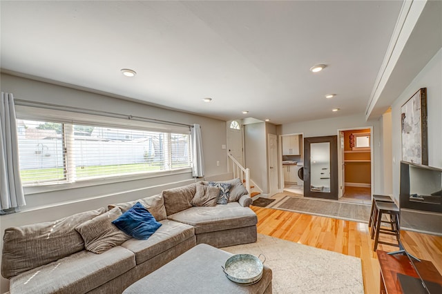 163 W 24th St, Deer Park, NY 11729 - living area featuring light wood-style flooring, stairway, recessed lighting, and washer / dryer