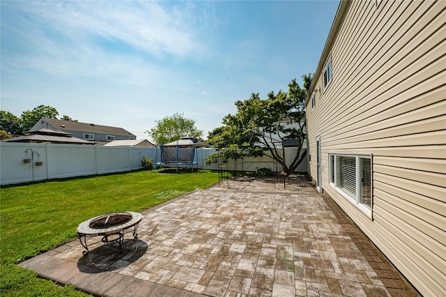163 W 24th St, Deer Park, NY 11729 - fenced backyard with a trampoline, a patio, and a fire pit