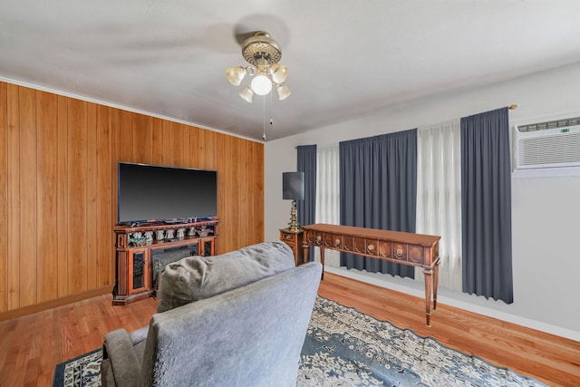 35 13th St, Bohemia, NY 11716 - living room featuring ceiling fan, wood finished floors, a wall unit AC, and wooden walls