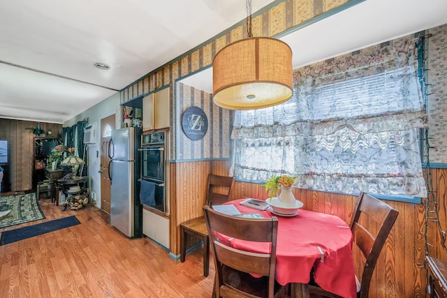 35 13th St, Bohemia, NY 11716 - dining area with wallpapered walls, wainscoting, wood finished floors, and wood walls