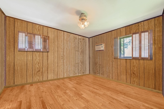 35 13th St, Bohemia, NY 11716 - empty room with wood finished floors, wood walls, and an AC wall unit