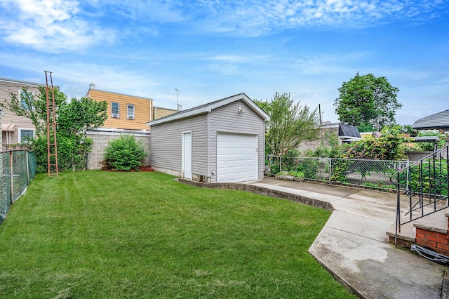 66-13 73rd Pl, Middle Village, NY 11379 - fenced backyard featuring concrete driveway, an outbuilding, and a detached garage