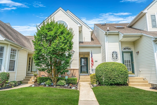 903 Constance Ln, Port Jefferson Station, NY 11776 - view of front facade featuring entry steps, a front yard, roof with shingles, and brick siding
