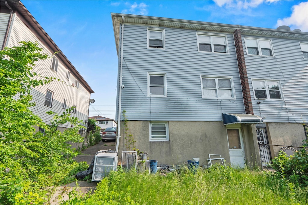 14019 Sutter Ave, South Ozone Park, NY 11436 - rear view of house with stucco siding