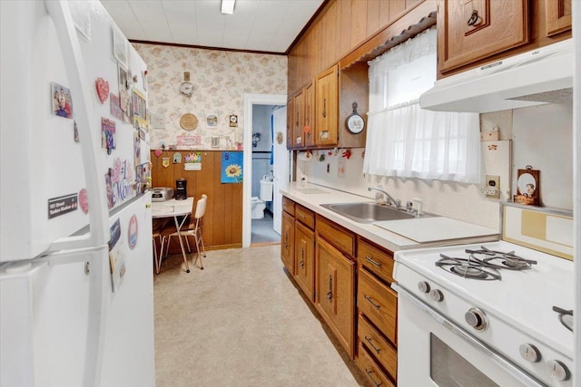 49 Boone St, Yonkers, NY 10704 - kitchen featuring under cabinet range hood, wallpapered walls, white appliances, brown cabinets, and ornamental molding