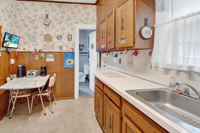 49 Boone St, Yonkers, NY 10704 - kitchen featuring wallpapered walls, wainscoting, brown cabinetry, and light countertops