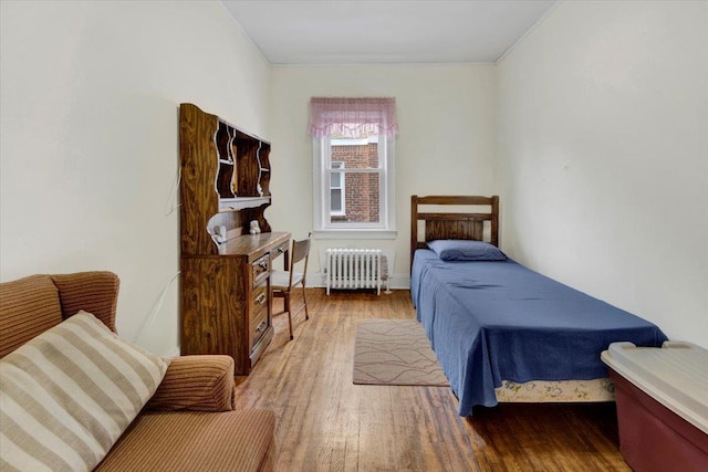 49 Boone St, Yonkers, NY 10704 - bedroom featuring radiator, wood finished floors, and ornamental molding