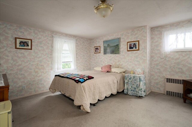 30 Nims Ave, West Babylon, NY 11704 - carpeted bedroom featuring radiator heating unit and wallpapered walls